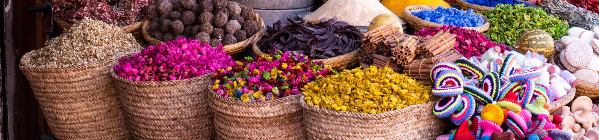 An image showcasing woven bags filled with colorful herbs, symbolizing health, balance, and weight loss. Part of Laroot World, a premium meal delivery service based in New York, featuring sustainable packaging and a focus on healthy, nutritious food options.