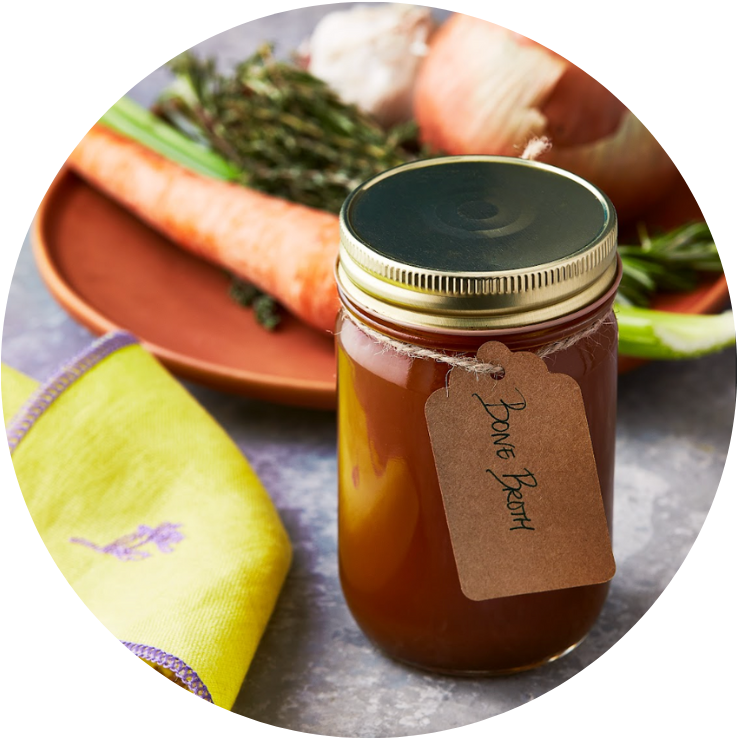 Bone broth and a dish of vegetables displayed for postpartum nutrition provided by Laroot World, an organic, local, gluten free New York City flexitarian, pescatarian, carnitarian, vegan, and vegetarian meal delivery service 