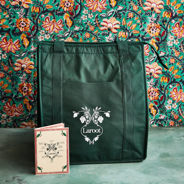 Laroot World green eco-friendly delivery bag with logo and menu displayed, set against a vibrant, colorful background