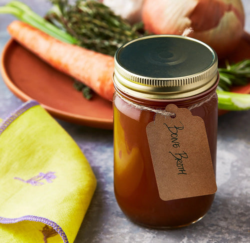 Bone broth and a dish of vegetables displayed for upcoming menu provided by Laroot World, an organic, local, gluten free New York City flexitarian, pescatarian, carnitarian, vegan, and vegetarian meal delivery service 