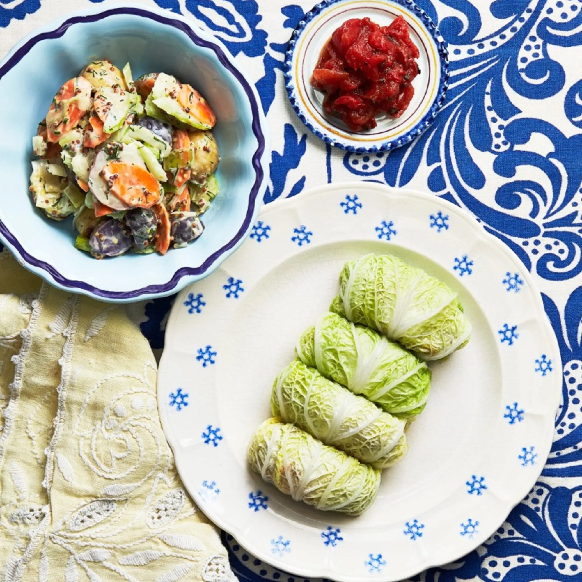 A plate of stuffed cabbage rolls on a tablecloth for upcoming menu provided by Laroot World, an organic, local, gluten free New York City flexitarian, pescatarian, carnitarian, vegan, and vegetarian meal delivery service 