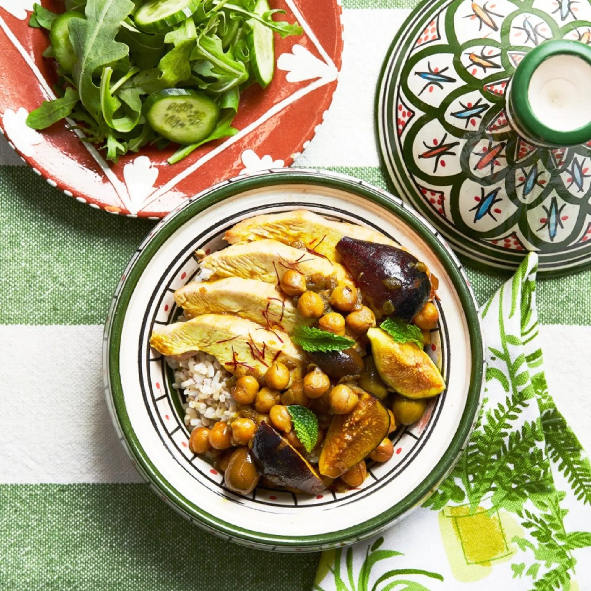 A closeup of a plate with Chicken & Fig tagine on a green tablecloth for upcoming menu provided by Laroot World, an organic, local, gluten free New York City flexitarian, pescatarian, carnitarian, vegan, and vegetarian meal delivery service 