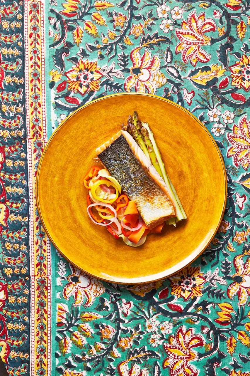 A plate of Salmon Escabeche on a tablecloth for upcoming menu provided by Laroot World, an organic, local, gluten free New York City flexitarian, pescatarian, carnitarian, vegan, and vegetarian meal delivery service 