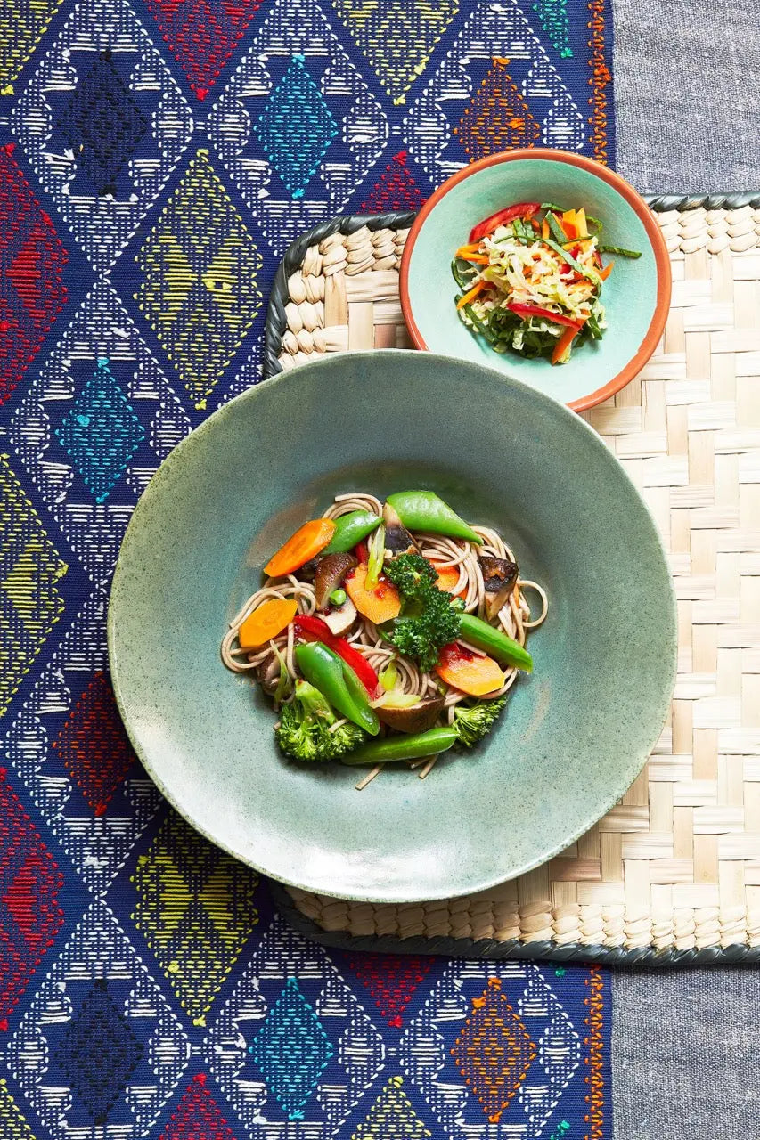 A plate of Singapore street noodles on a tablecloth for upcoming menu provided by Laroot World, an organic, local, gluten free New York City flexitarian, pescatarian, carnitarian, vegan, and vegetarian meal delivery service 