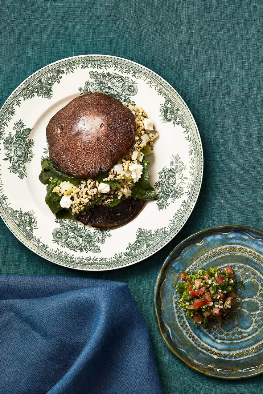 A plate with stuffed portobello mushrooms on a tablecloth for upcoming menu provided by Laroot World, an organic, local, gluten free New York City flexitarian, pescatarian, carnitarian, vegan, and vegetarian meal delivery service 